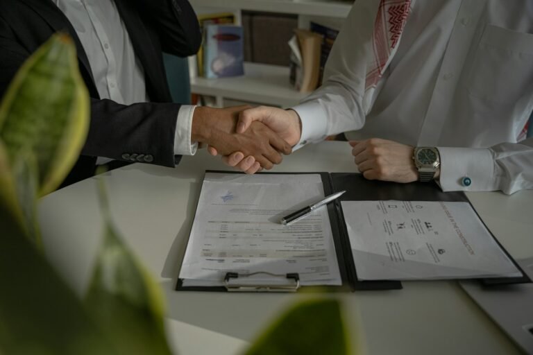 Two people shaking hands over an agreement