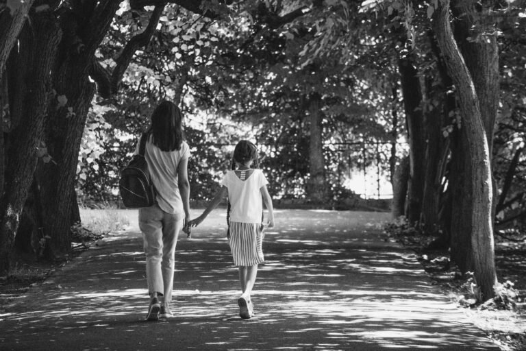 Parent and child walking along a path